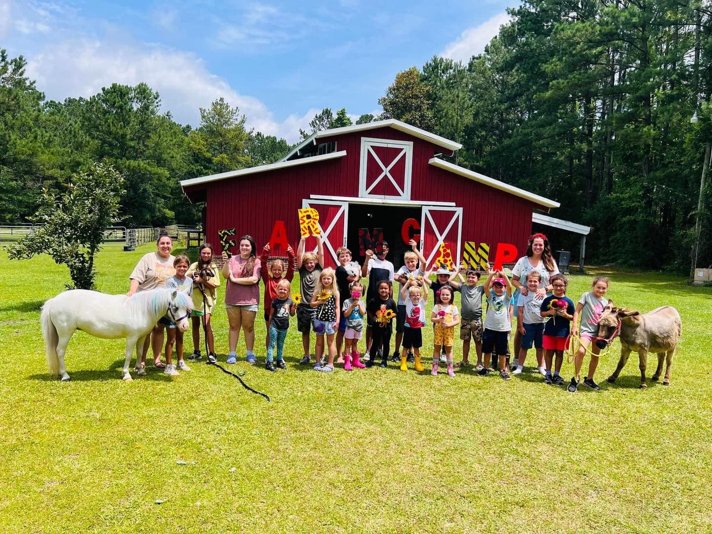 Group in front of the Red Barn with animals